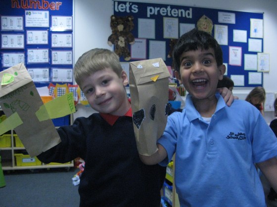 Two students enjoy showing off their hand made puppets!
